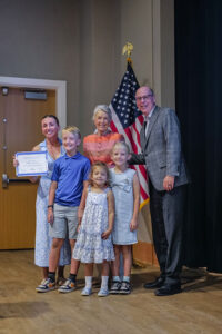 Group of people presenting a scholarship to a Moorings Park partner