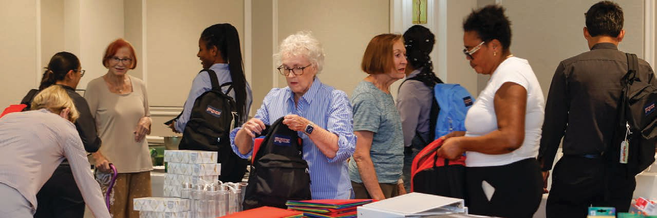 Moorings Park residents filling backpacks with school supplies