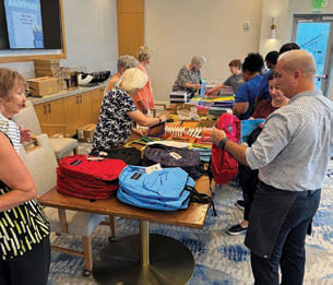 Mooring Park residents working on filling backpacks