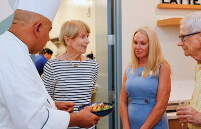 Jessica Short , John Rakoske, and Connie Rakoske talking with the chef